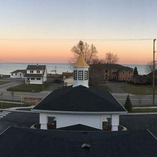 A peaceful sunset view over lakeside houses with a vibrant sky.