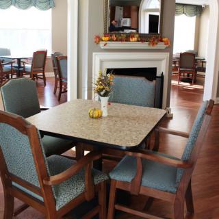 A cozy dining area with a table and chairs, featuring elegant decor.