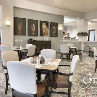 A modern and elegant dining area featuring comfortable seating and artistic wall decor.