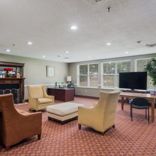 A cozy living room with comfortable seating and a large television.