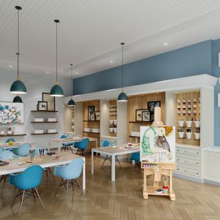 A modern art studio with easels and vibrant seating, showcasing a variety of art supplies in an inspiring creative space.