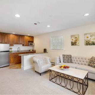 A cozy open floor plan living room and kitchen with comfortable seating and modern decor.