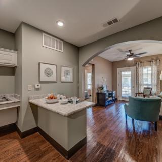 An open-concept kitchen and living area featuring modern decor and hardwood flooring.