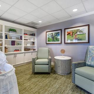 A comfortable waiting room with seating and art-adorned walls.
