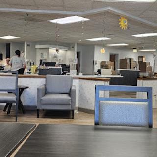 A modern office waiting area featuring comfortable seating and a bright, open layout.