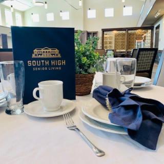 Elegant table setting with a menu at South High House Cafe.