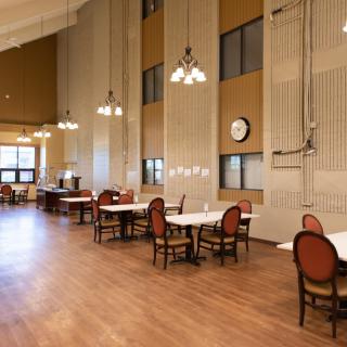 A spacious dining area with elegant furnishings and high ceilings.