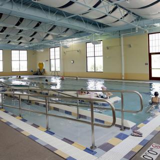 An indoor swimming pool designed for rehabilitation, equipped with accessibility features.