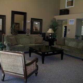 A cozy living room with sofas, an armchair, and a coffee table.