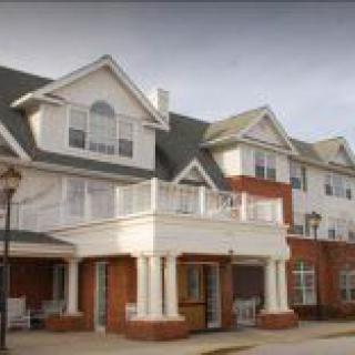 A multi-story residential building with a spacious balcony.