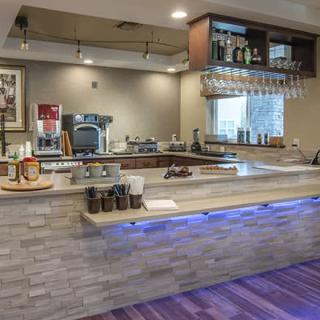 A modern coffee shop counter with various drinks and equipment.