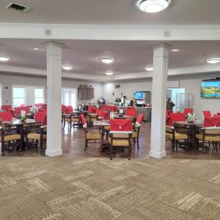 A spacious dining area with modern decor and neatly arranged tables and chairs.