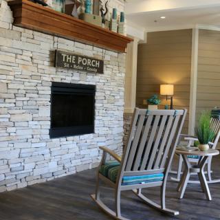A cozy living room with a fireplace and rocking chairs.