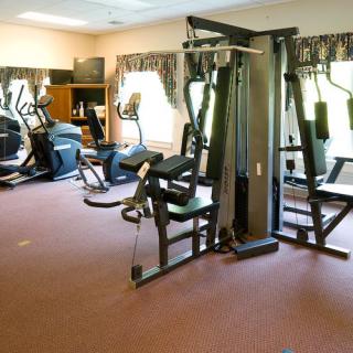 A well-equipped gym with various exercise machines for fitness enthusiasts.
