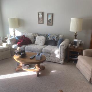A cozy living room with a comfortable sofa and matching lamps on either side.