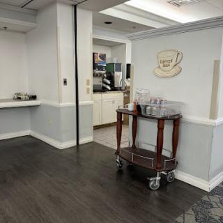 A view of a stylish reception area featuring a wooden cart and a welcoming ambiance.