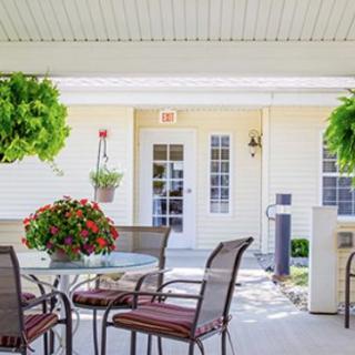 A cozy outdoor patio area with seating and vibrant plants.