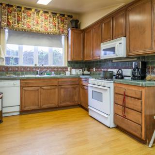 A cozy kitchen with wooden cabinets and modern appliances.