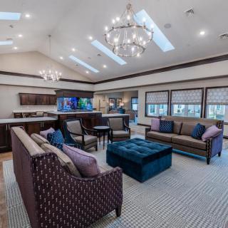 Spacious living room with elegant chandeliers and stylish furniture.