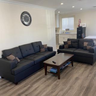 A modern living room with a comfortable sofa set, a coffee table, and wood flooring.