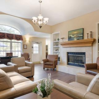 A cozy living room featuring comfortable sofas, a fireplace, and elegant decor.
