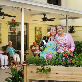 A group of elderly individuals enjoying gardening and spending time outdoors together.