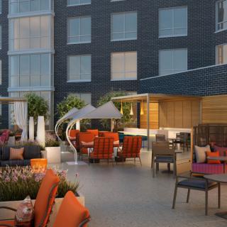 Modern hotel patio with colorful seating and stylish decor.