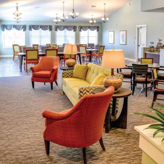 A spacious lounge area with comfortable seating and colorful furniture.