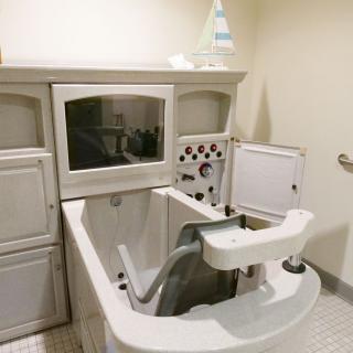 An assisted bathing tub in a healthcare facility, designed for safe and comfortable patient care.