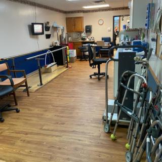 A rehabilitation therapy room equipped with various assistive devices for patient recovery.
