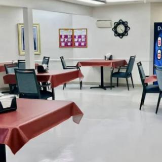 A clean and empty dining area with neatly arranged tables and chairs, ready for guests.