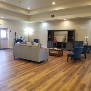 Spacious living room with modern furniture and hardwood flooring.