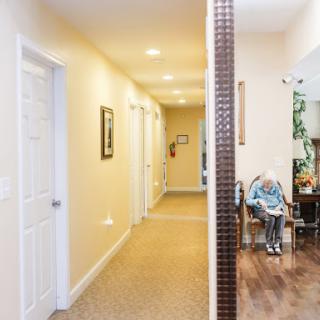 A spacious interior hallway leading to various rooms, showcasing a cozy living area with furniture.