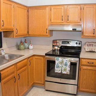 A modern kitchen with wooden cabinets and stainless steel appliances.