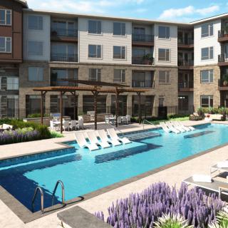 A modern apartment complex featuring a swimming pool and lounge area.