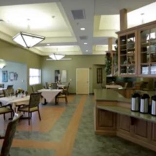 A spacious dining room with arranged tables and modern lighting.