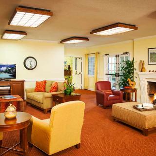 A cozy living room with comfortable seating and warm lighting.