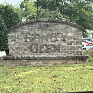 Entrance sign for Trinity Glen community, made of brick with a classic design.