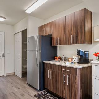 A modern kitchen with wood cabinets and stainless steel appliances.