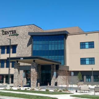 A modern healthcare center showcasing a blend of stone and glass design.
