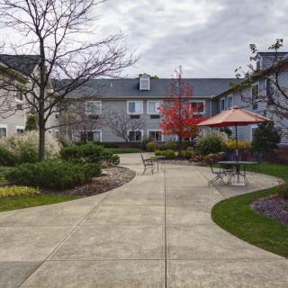 A serene courtyard with pathways, landscaping, and outdoor seating.