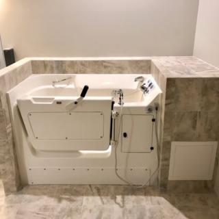 A modern walk-in bathtub in a bathroom with a focus on accessible design.
