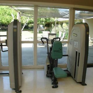 A well-lit gym area featuring exercise equipment.
