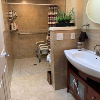 A well-designed bathroom featuring modern fixtures, a spacious layout, and decorative elements.