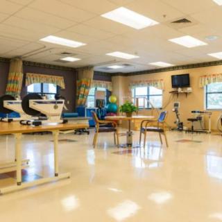 A well-equipped rehabilitation center with exercise equipment and therapy areas.