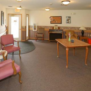 A cozy lobby with comfortable seating and a table, creating a welcoming waiting area.