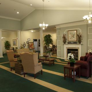A cozy lobby with comfortable seating and a fireplace, decorated in traditional style.