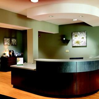 A modern reception area with a curved desk and contemporary decor.