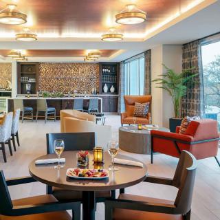A modern lounge featuring a cozy seating area with a bar and stylish decor.
