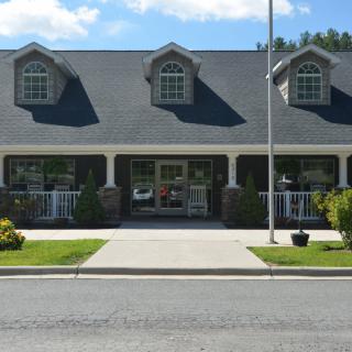 A suburban commercial building with a storefront entrance and well-maintained landscaping.
